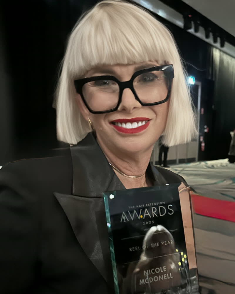 Nicole holding the Reel of the Year trophy at the Hair Extension Awards.