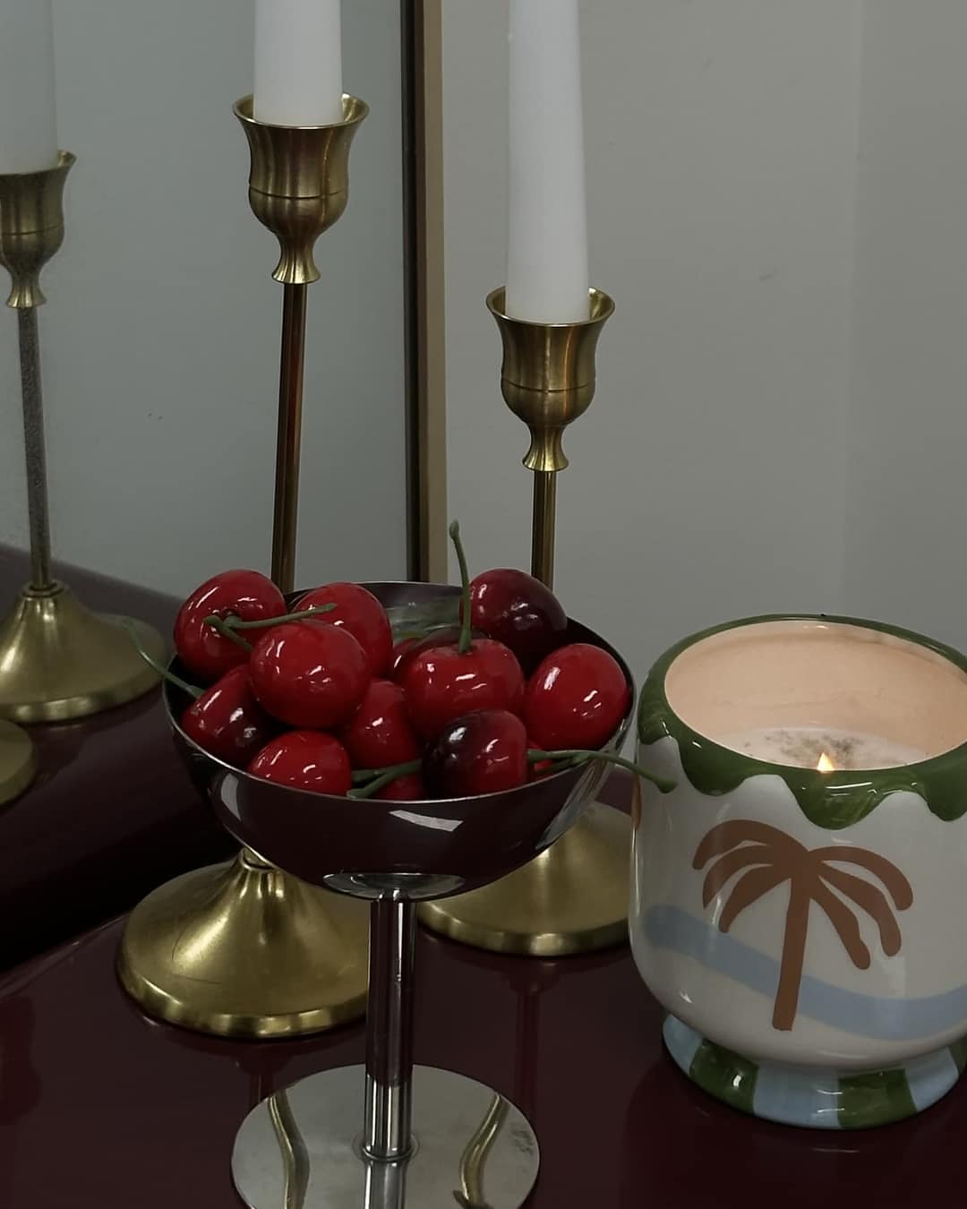 Cherries and candles on the studio table.